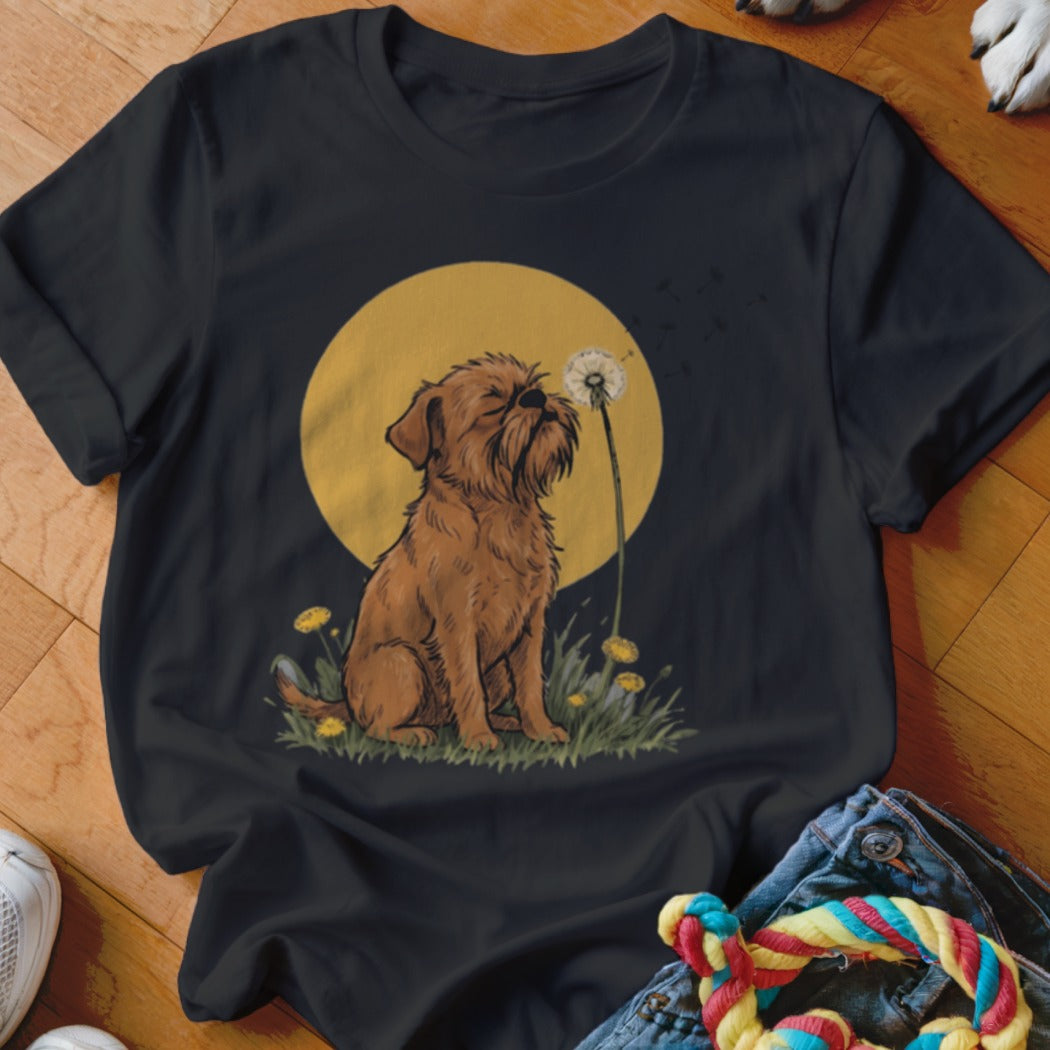 A black crewneck t-shirt featuring an illustration of a brown dog blowing dandelion seeds against a yellow circle background.