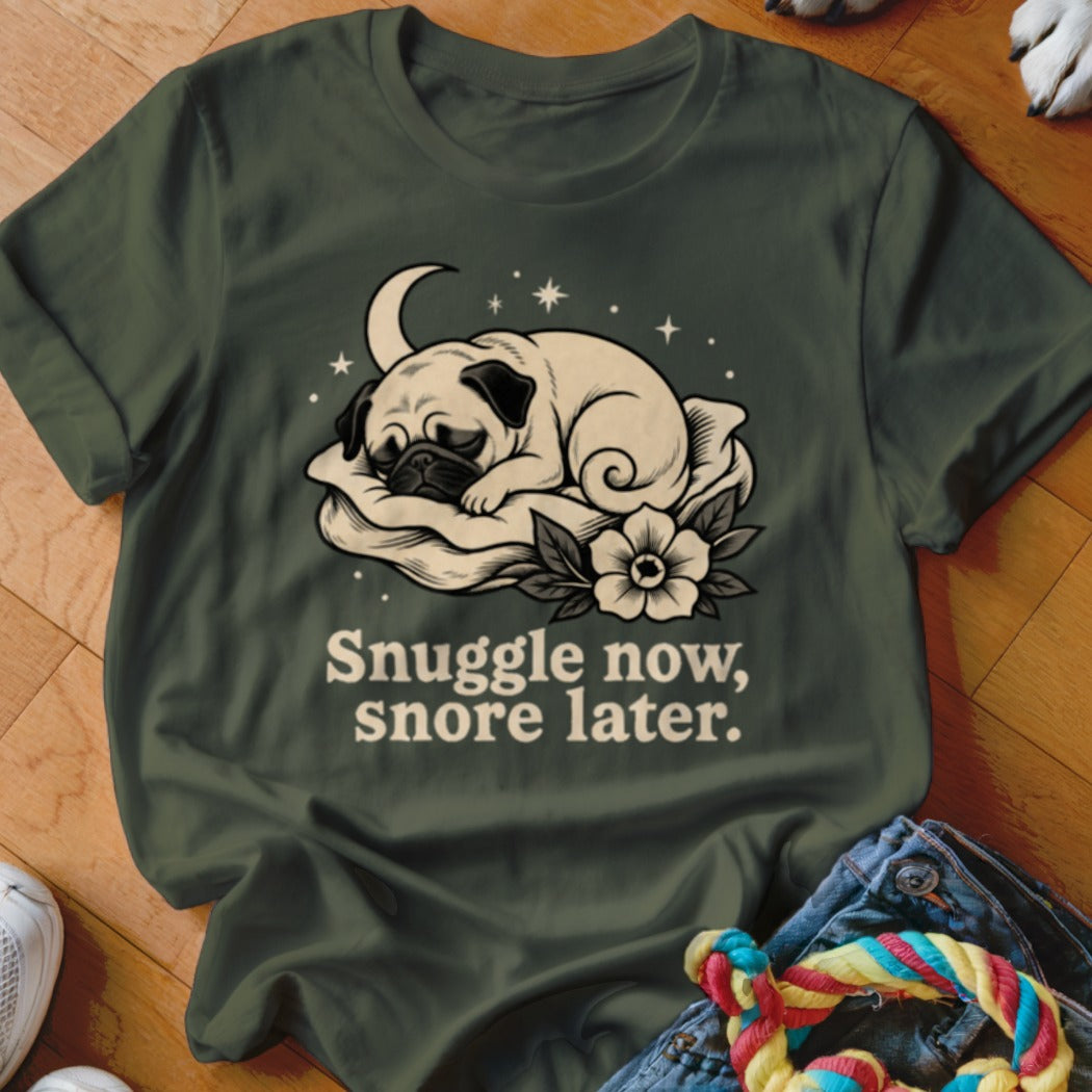 Green t-shirt with pug sleeping on pillow and text "Snuggle now, snore later."