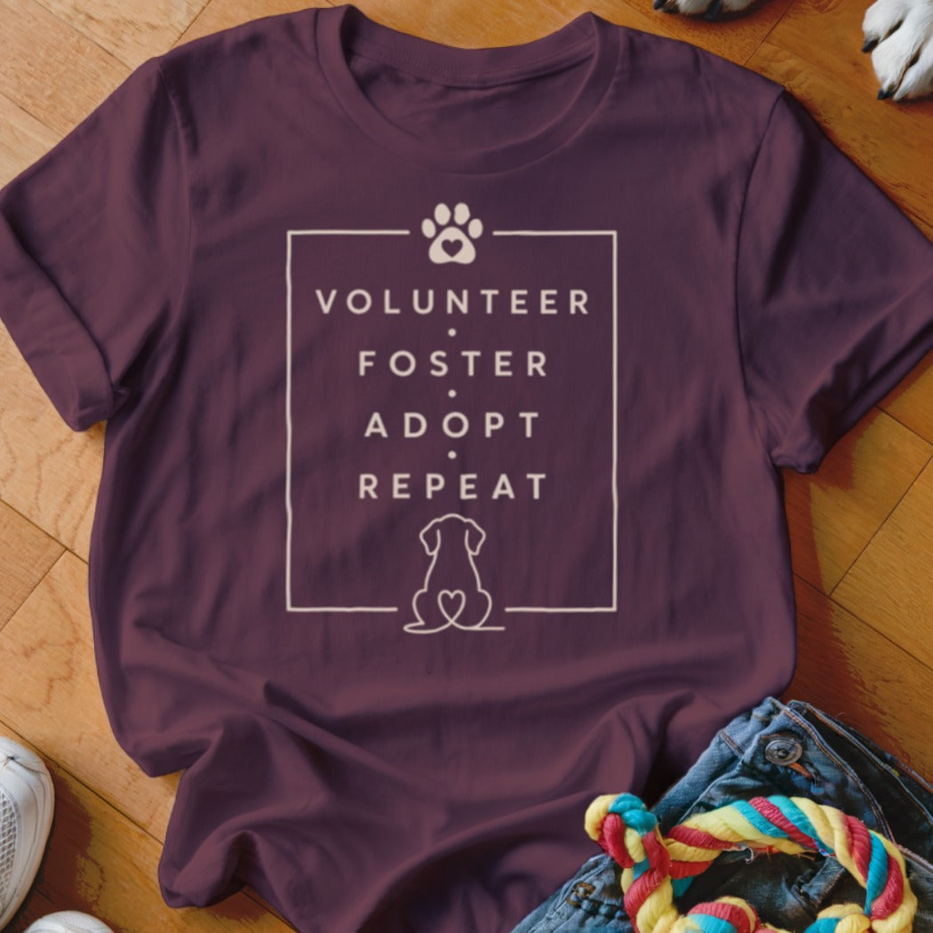 Maroon t-shirt with "Volunteer Foster Adopt Repeat" text and dog footprint.
