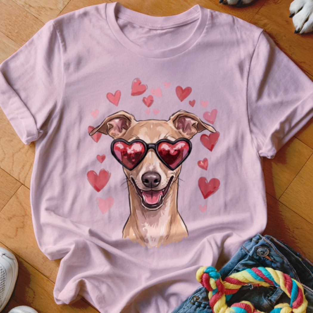 Light pink t-shirt featuring an illustration of a smiling dog wearing heart-shaped sunglasses surrounded by floating hearts.