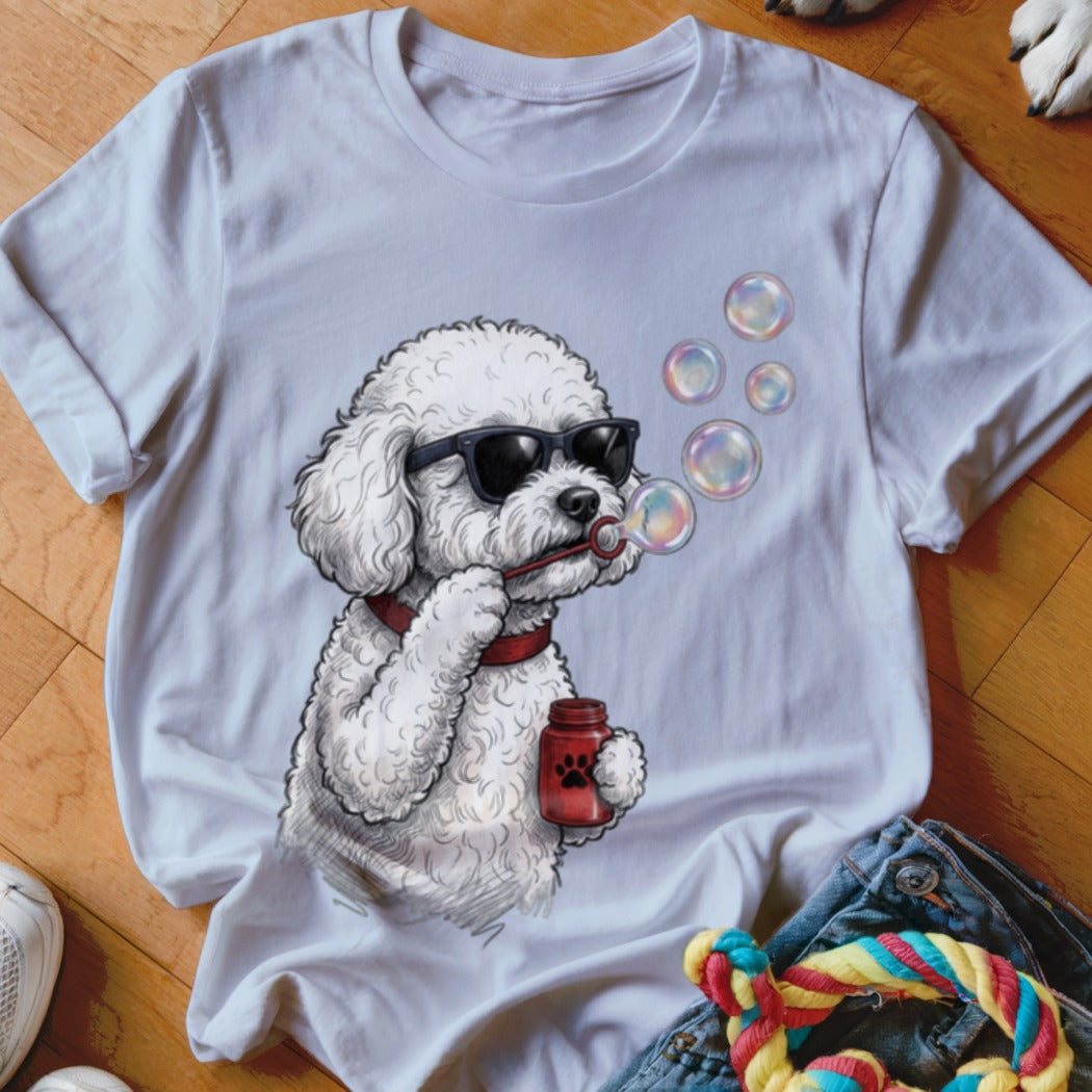 White t-shirt featuring a cartoon poodle wearing sunglasses and blowing bubbles while holding a bottle.