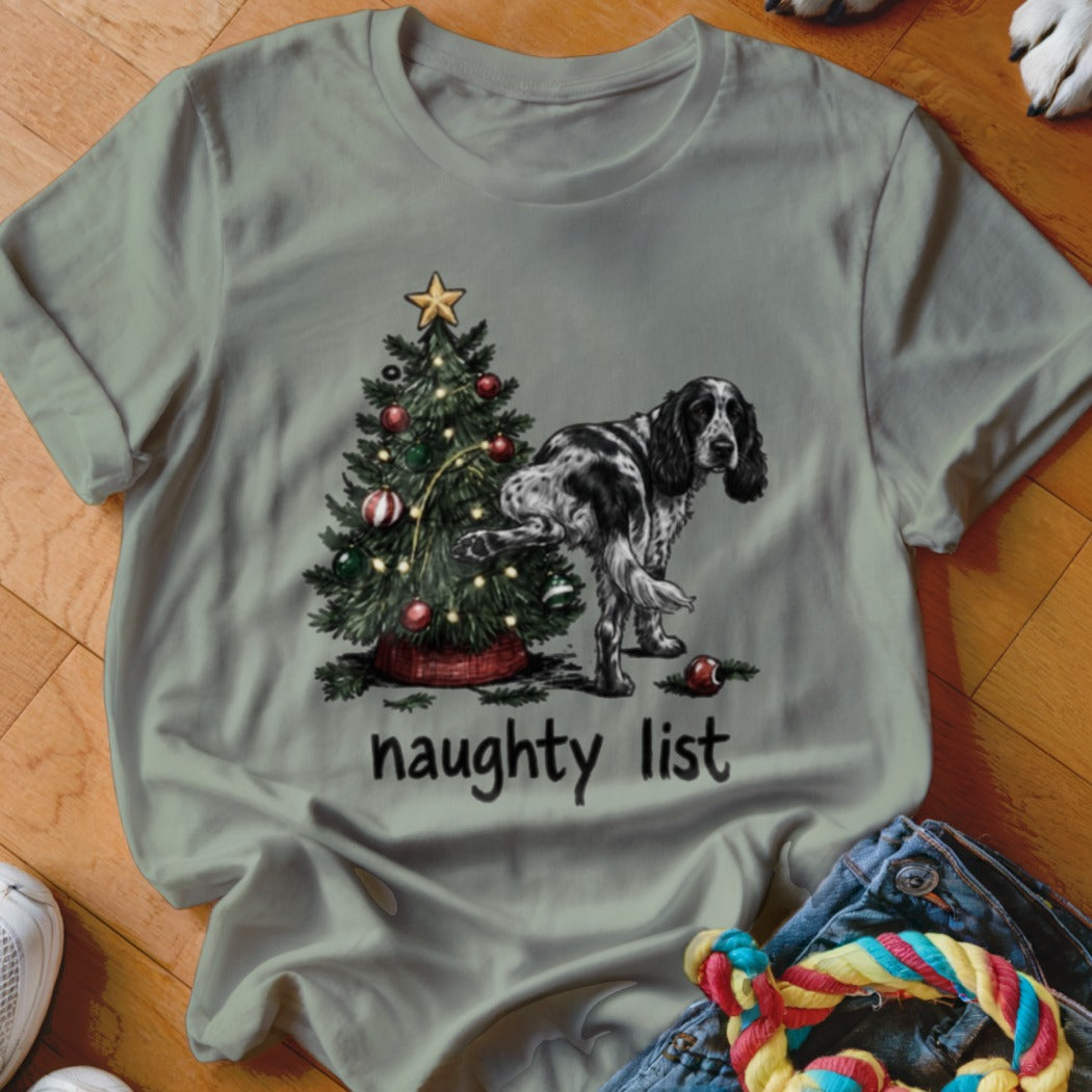Dog lifting leg on Christmas tree with text "naughty list"
