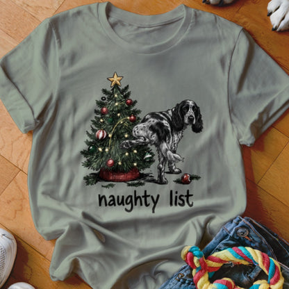 Dog lifting leg on Christmas tree with text "naughty list"