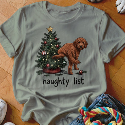 Brown dog lifting leg on Christmas tree with "naughty list" text.