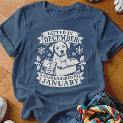T-shirt with a puppy in a box and text "Gifted in December, Surrendered in January."