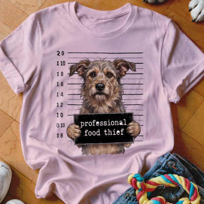 Pink t-shirt featuring a scruffy dog in a mugshot with "professional food thief" sign.