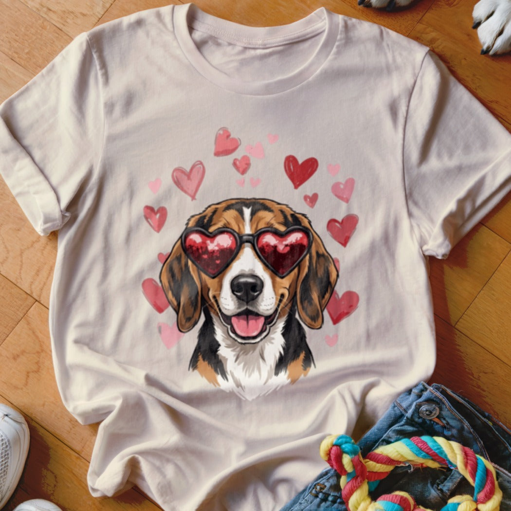 Beige t-shirt featuring a beagle wearing heart-shaped sunglasses, surrounded by pink and red hearts.