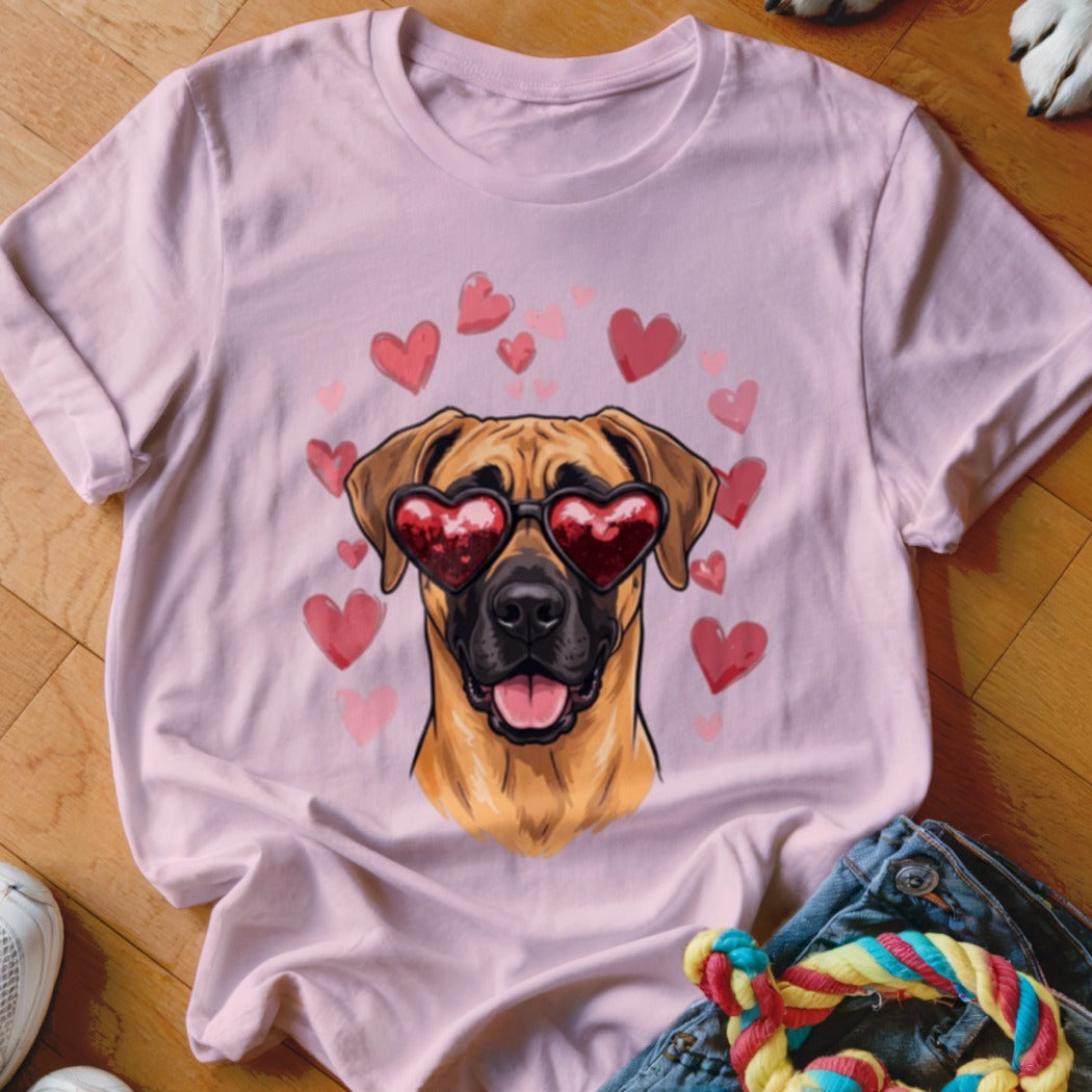 A light pink t-shirt features a cartoon dog wearing heart-shaped sunglasses surrounded by pink hearts.
