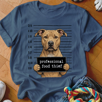 Tan dog in mugshot holding sign that says "professional food thief."