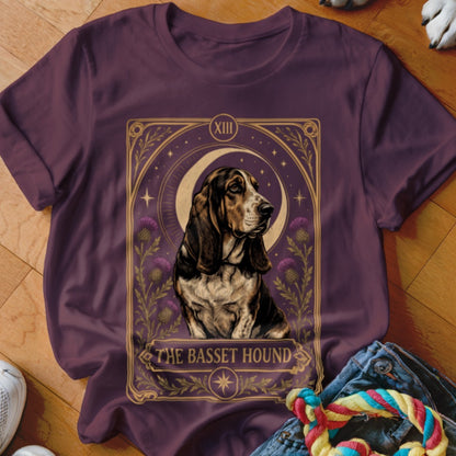 Maroon t-shirt featuring a tarot card graphic of a basset hound, crescent moon, and thistles.