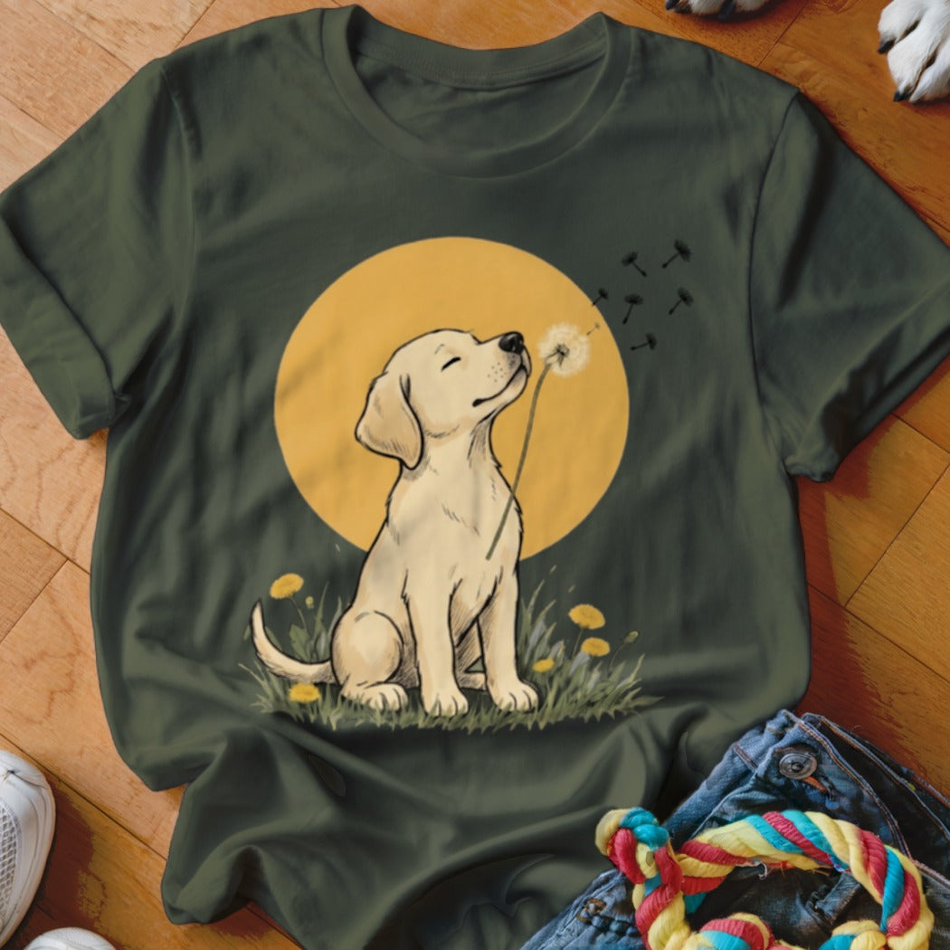 Dark green crewneck t-shirt featuring a graphic of a yellow lab puppy blowing dandelion seeds against a yellow moon.