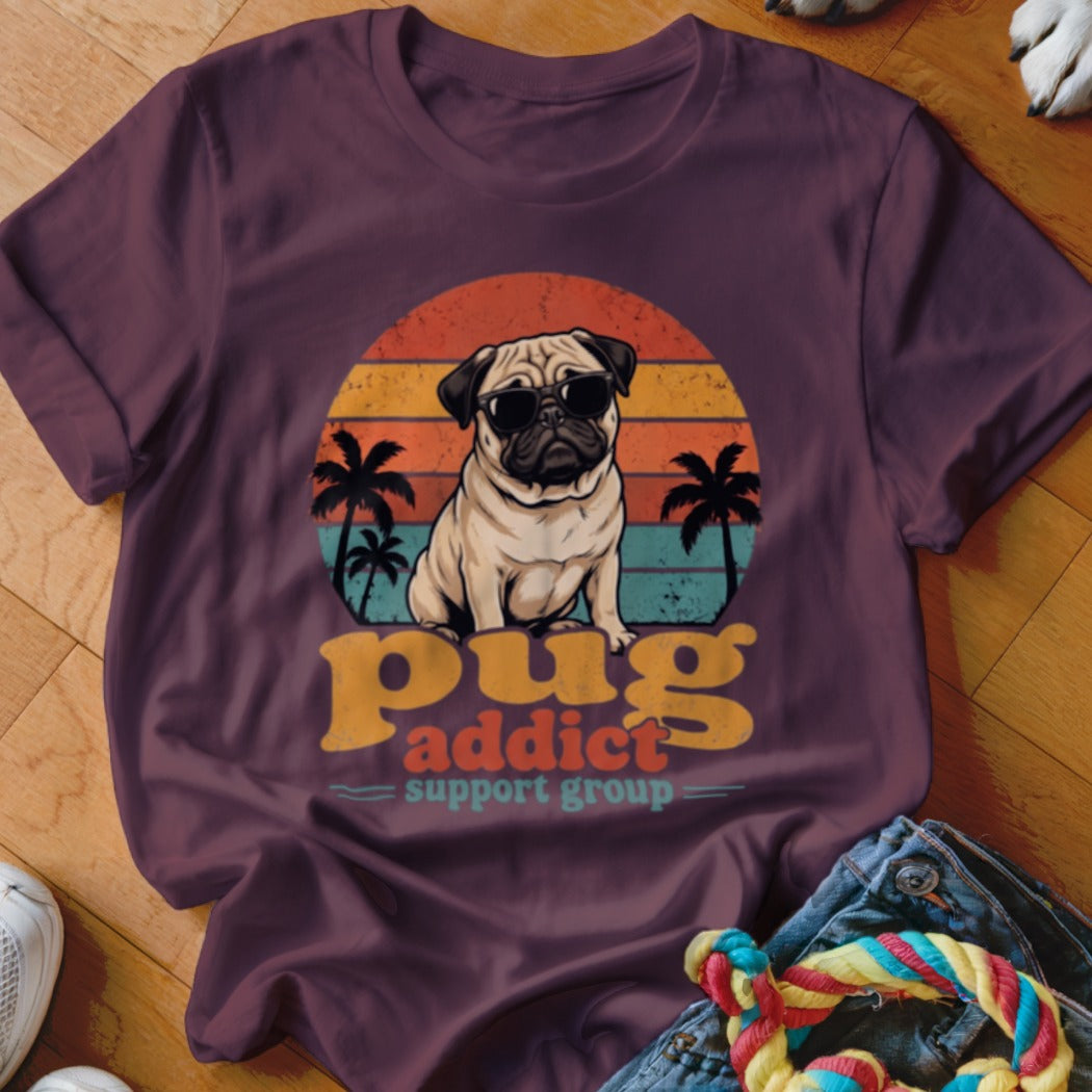 Maroon t-shirt featuring a pug in sunglasses, sunset, palm trees, and the text pug addict support group.