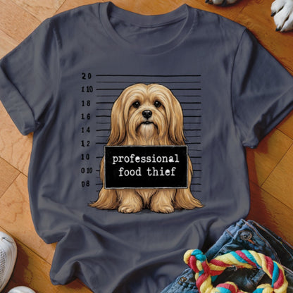 Dog mugshot with "professional food thief" sign.