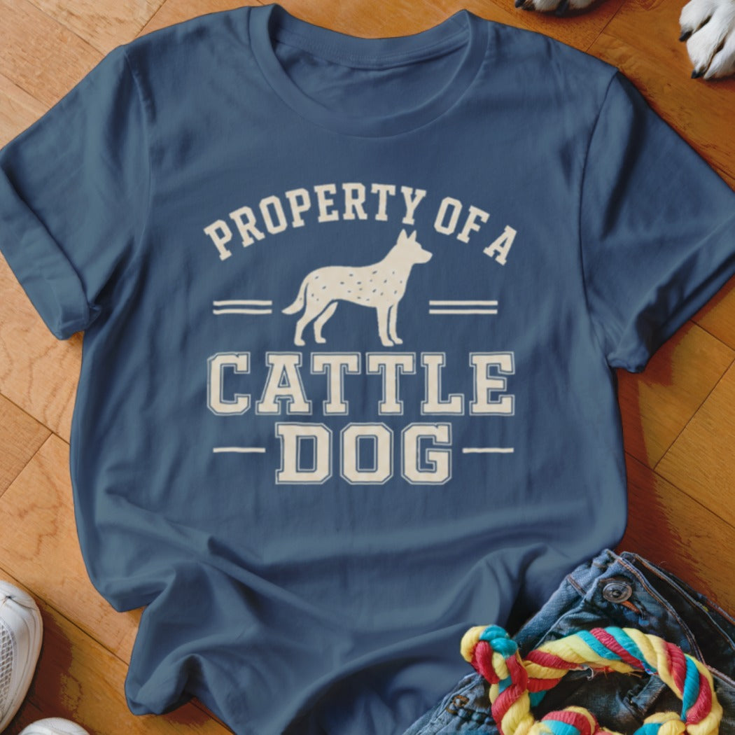 Blue t-shirt with white text "PROPERTY OF A CATTLE DOG" and a silhouette of a cattle dog.