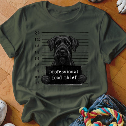 Black Schnauzer in mugshot with "professional food thief" sign.