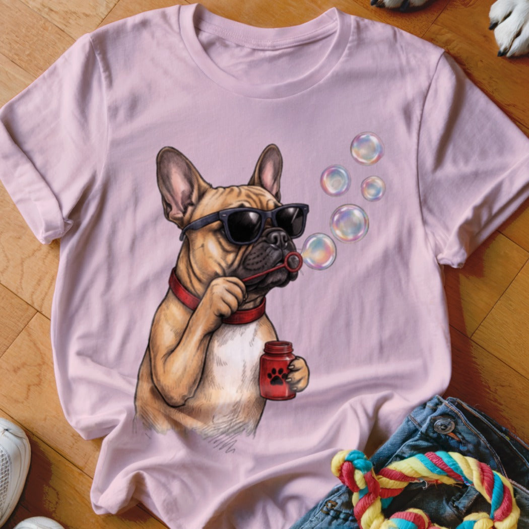 A light pink crewneck t-shirt featuring a graphic of a French bulldog wearing sunglasses and blowing bubbles.