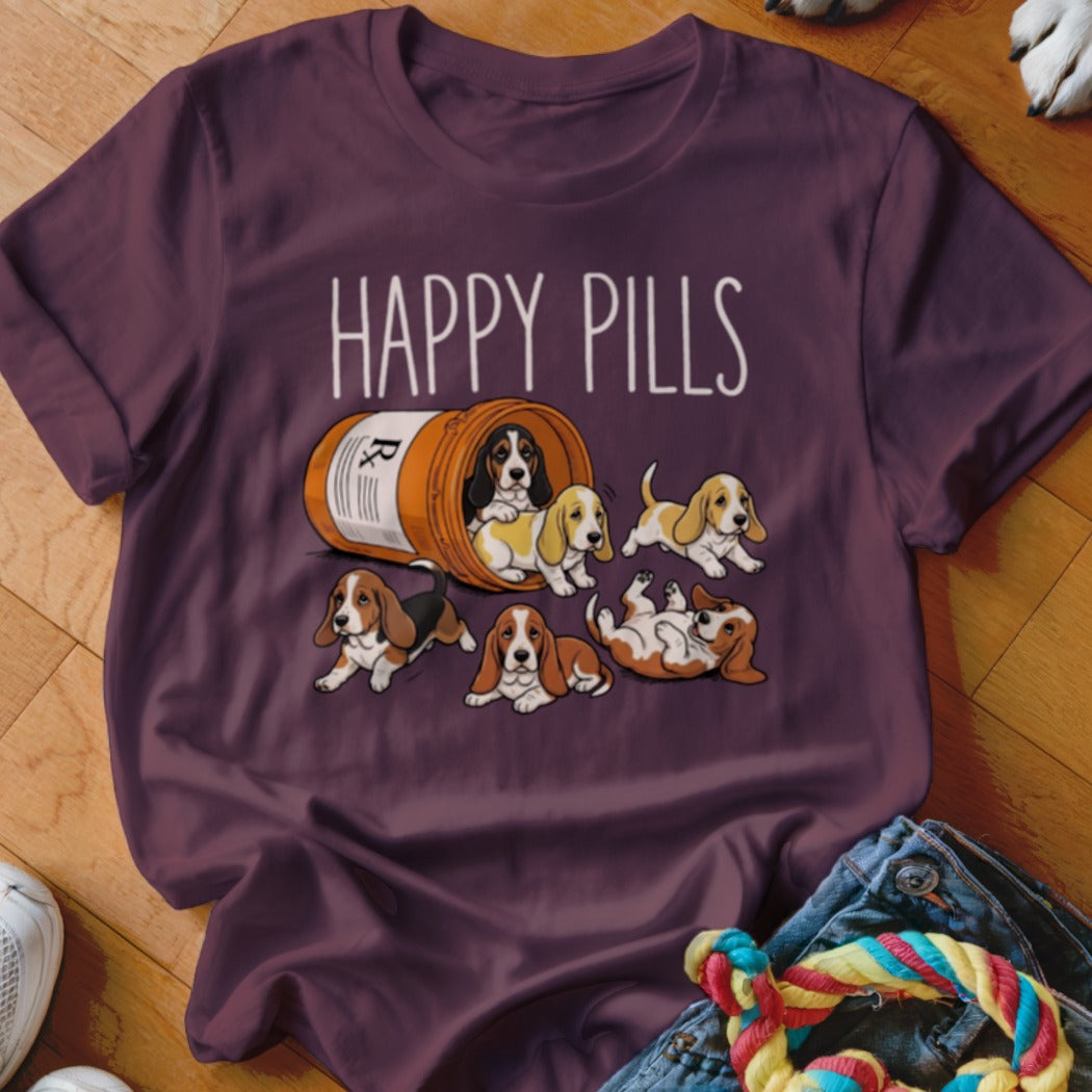 Maroon t-shirt with "HAPPY PILLS" and a prescription bottle overflowing with Basset Hound puppies.