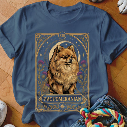 A blue t-shirt featuring a tarot card graphic of a Pomeranian dog with the text The Pomeranian.