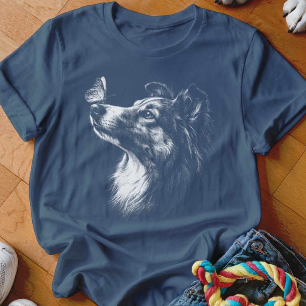 Dark blue t-shirt featuring a white sketch of a collie looking at a butterfly on its nose.