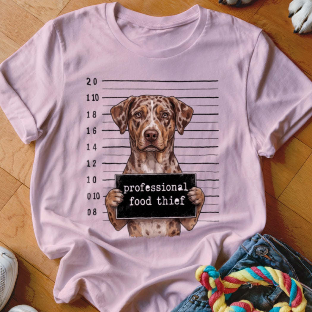 Catahoula dog mugshot with sign reading "professional food thief".