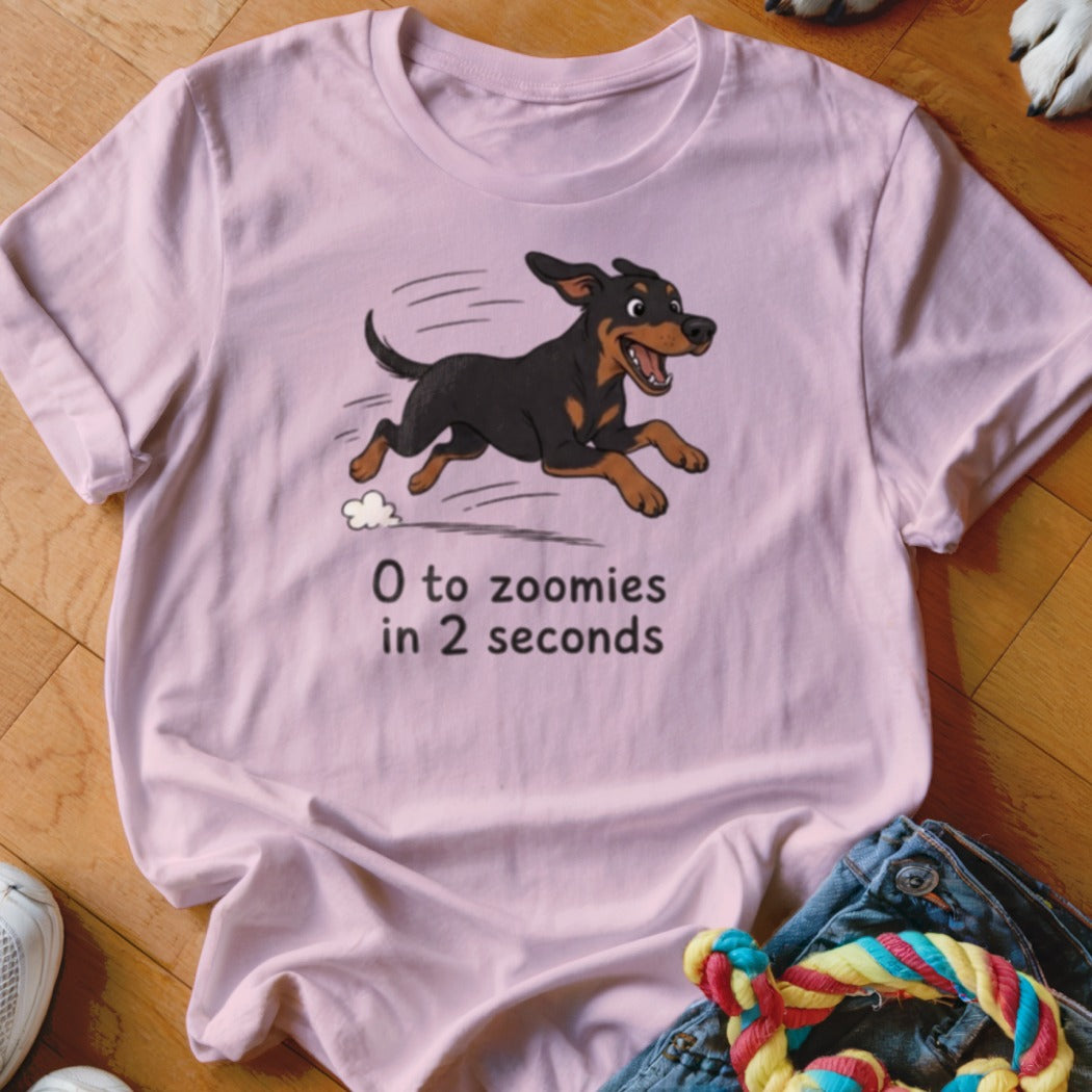 Pink t-shirt with cartoon dog running and text "0 to zoomies in 2 seconds".