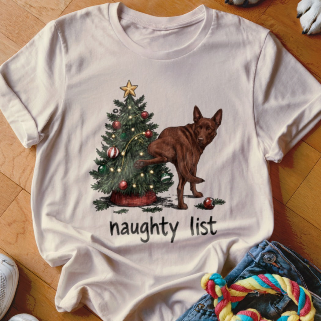 Brown dog next to Christmas tree with text "naughty list".