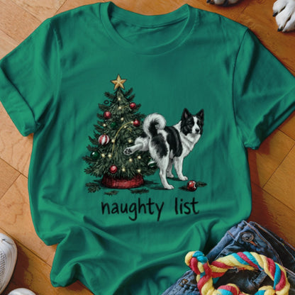 A green T-shirt features a graphic of a black and white dog urinating on a decorated Christmas tree above the text naughty list.