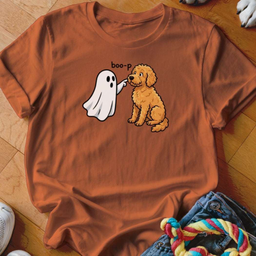Orange t-shirt with cartoon ghost booping a golden doodle dog.