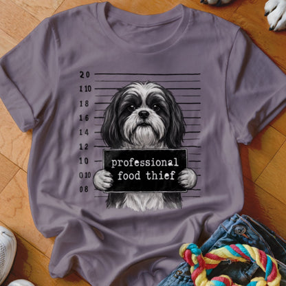 Shih Tzu mugshot with "professional food thief" sign.