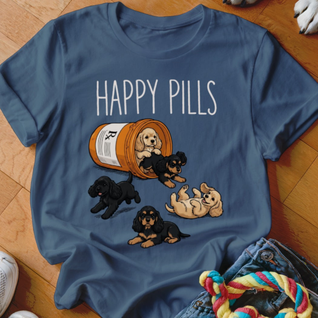 T-shirt with "Happy Pills" text and cartoon puppies spilling out of a pill bottle.