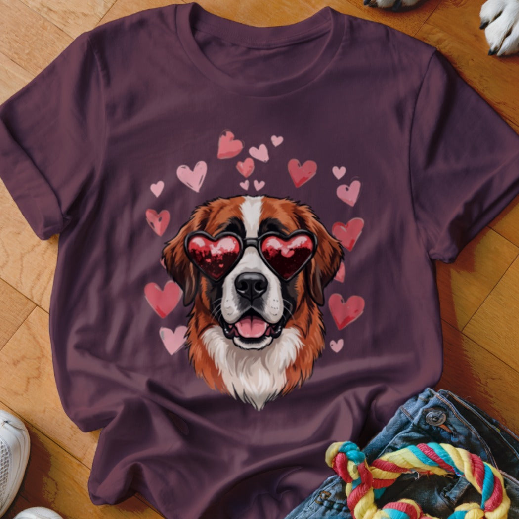 A maroon t-shirt featuring a Saint Bernard wearing heart-shaped sunglasses surrounded by pink hearts.