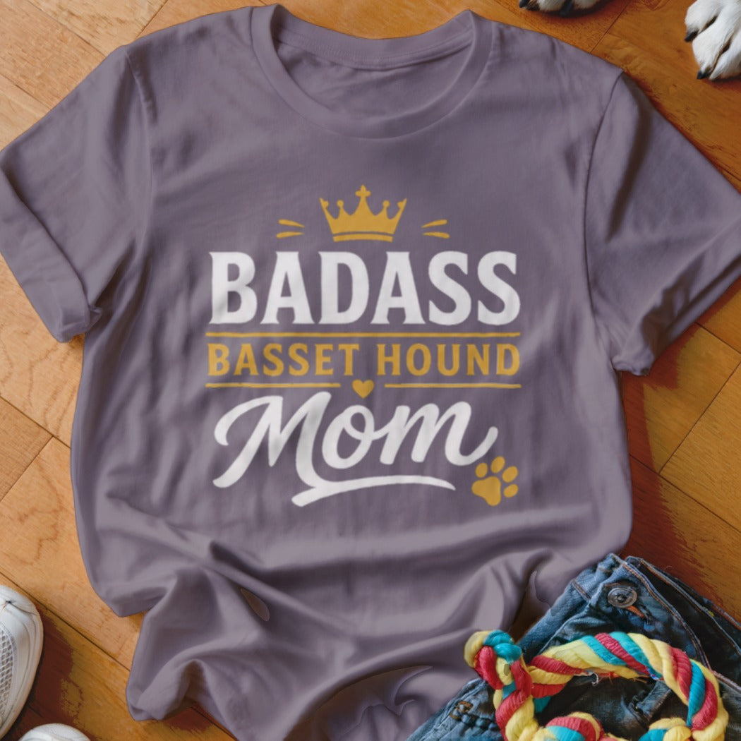 Purple t-shirt with "Badass Basset Hound Mom" text, crown, and paw print.