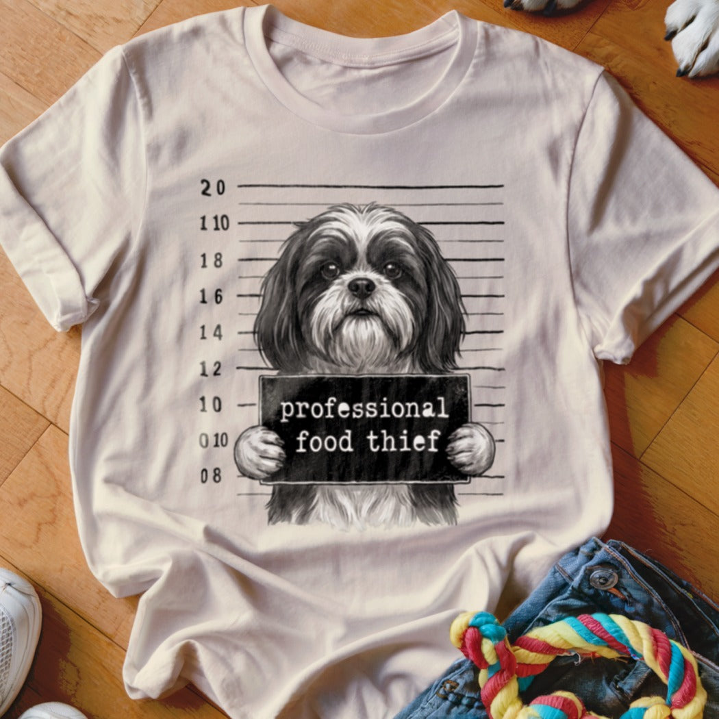 T-shirt graphic of a shih tzu dog with a "professional food thief" sign.
