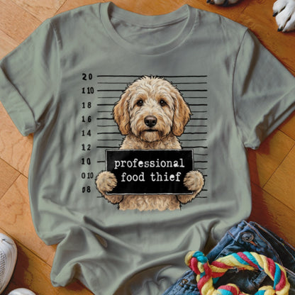 Goldendoodle in mugshot holding sign saying "professional food thief".
