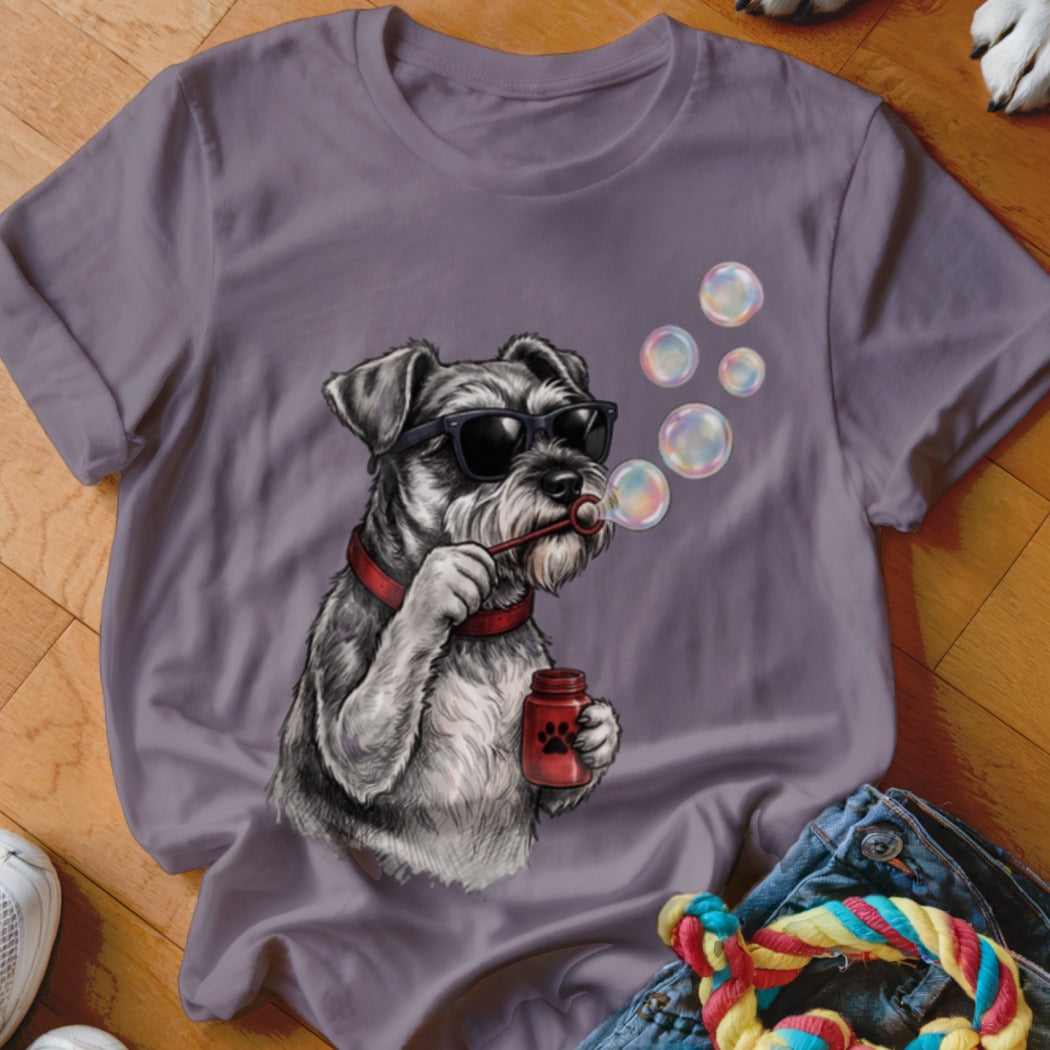 A purple t-shirt featuring a graphic of a schnauzer wearing sunglasses and blowing bubbles.