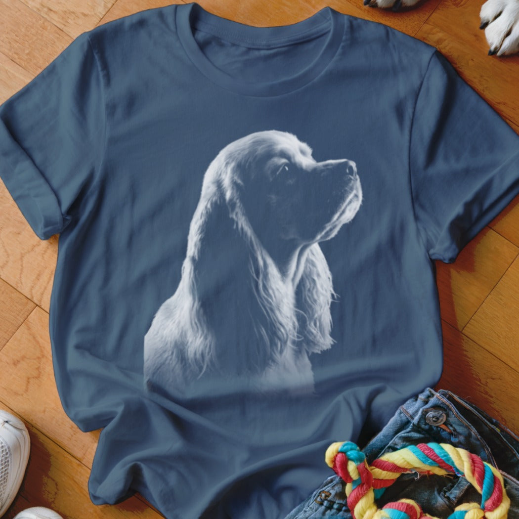 Blue t-shirt with a white outline sketch of a Cocker Spaniel dog's head.