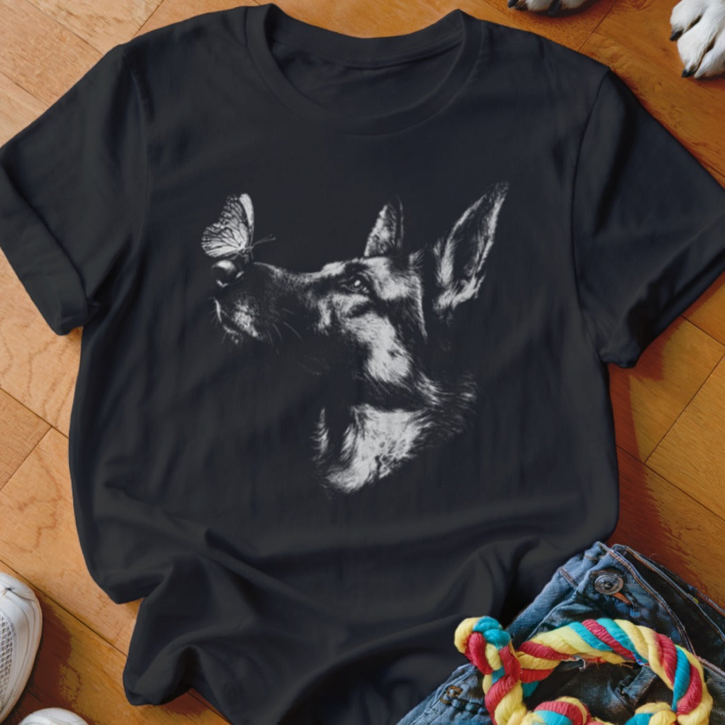 A black crewneck t-shirt featuring a white graphic of a German Shepherd with a butterfly on its nose.