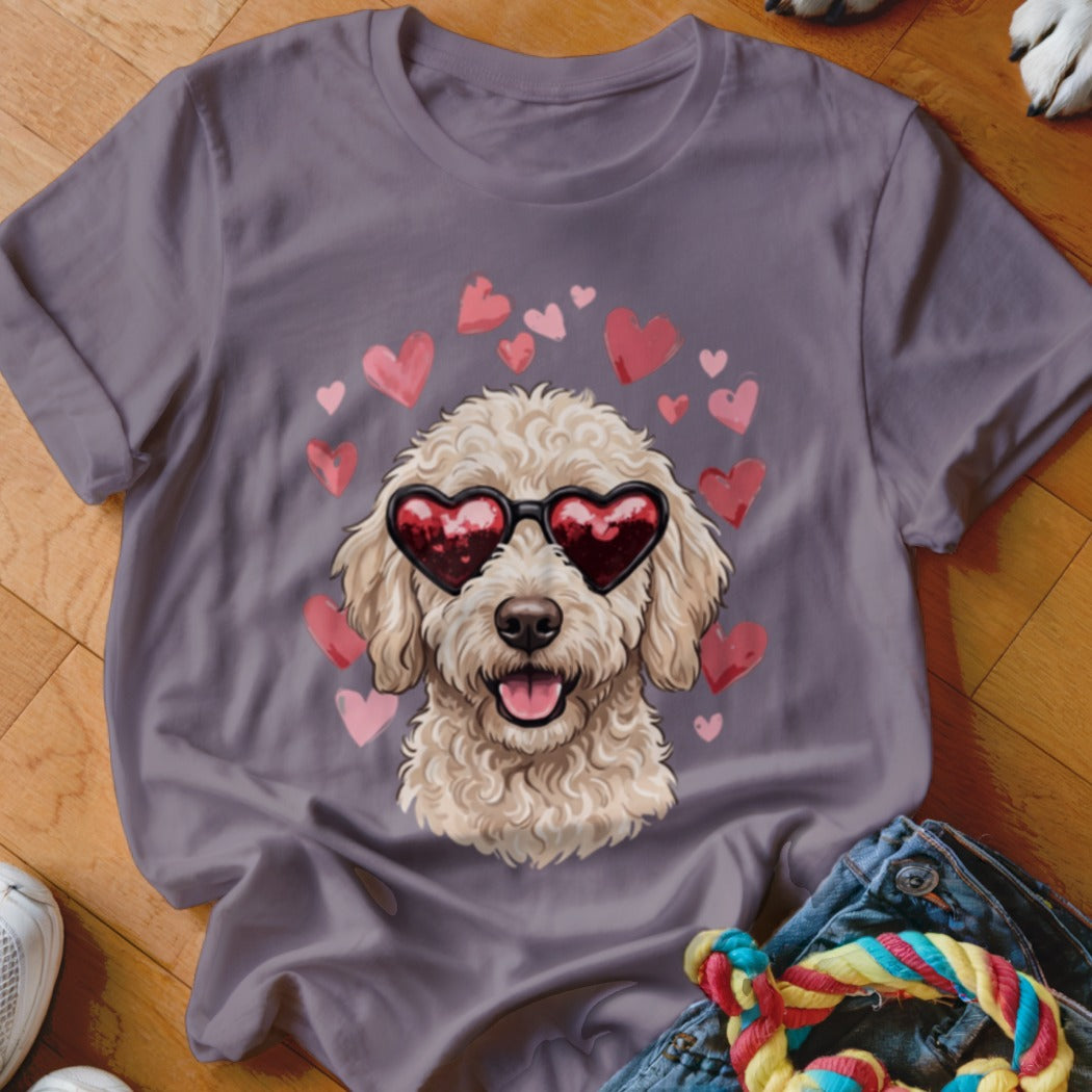 A gray t-shirt featuring a graphic of a curly doodle dog wearing heart-shaped sunglasses surrounded by pink hearts.