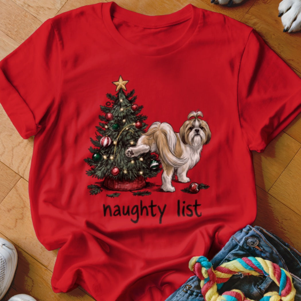 Red t-shirt featuring a graphic of a Shih Tzu lifting its leg on a Christmas tree with the text naughty list.