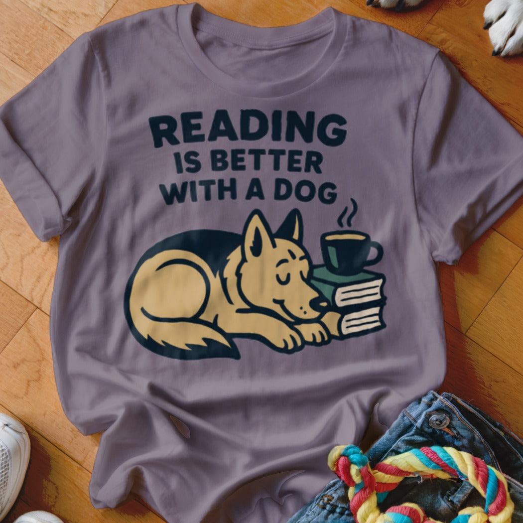 T-shirt with text "READING IS BETTER WITH A DOG" and illustrated sleeping dog.