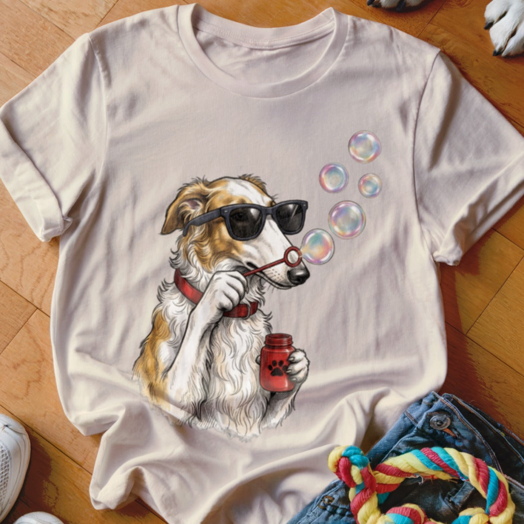 A light pink t-shirt features a graphic of a dog wearing sunglasses and blowing bubbles.