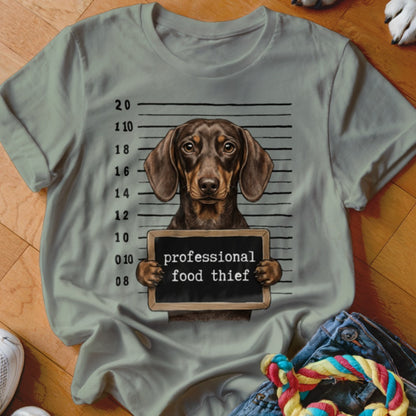 Dachshund mugshot with "professional food thief" text on chalkboard.