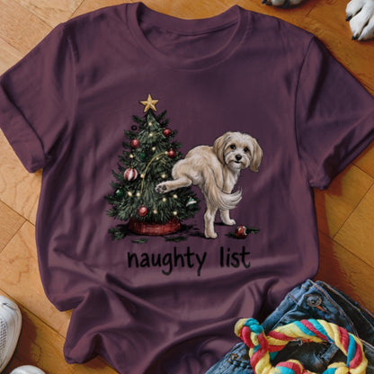 T-shirt with a Christmas tree, a playful dog, and the text "naughty list".