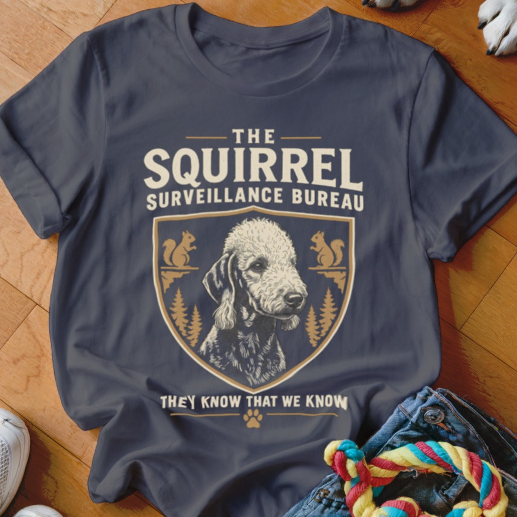 Charcoal t-shirt featuring a dog graphic, crest, and text that reads The Squirrel Surveillance Bureau.