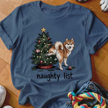 Siberian husky next to Christmas tree with text "naughty list".