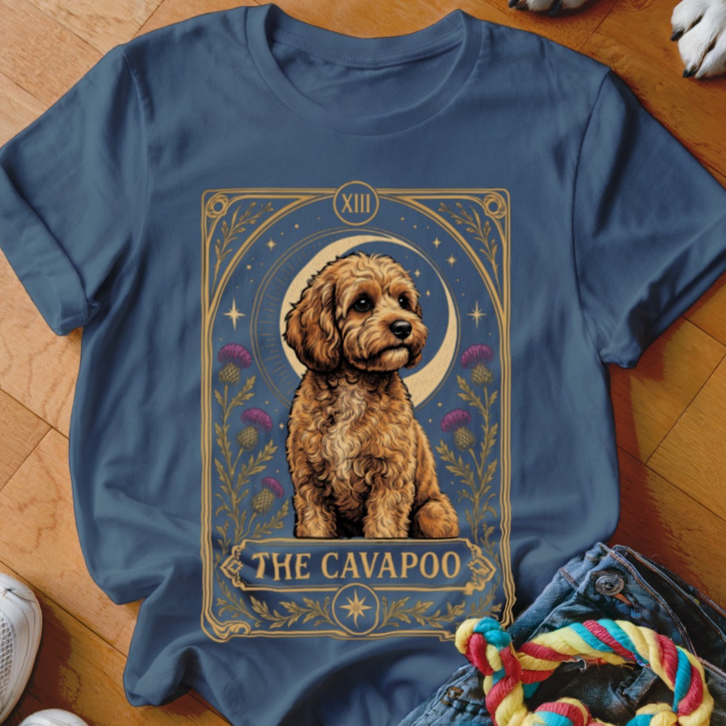 Navy blue t-shirt featuring a tarot card graphic of a Cavapoo surrounded by flowers and stars.