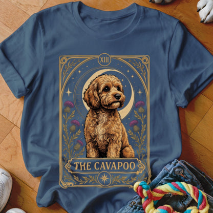 Navy blue t-shirt featuring a tarot card graphic of a Cavapoo surrounded by flowers and stars.