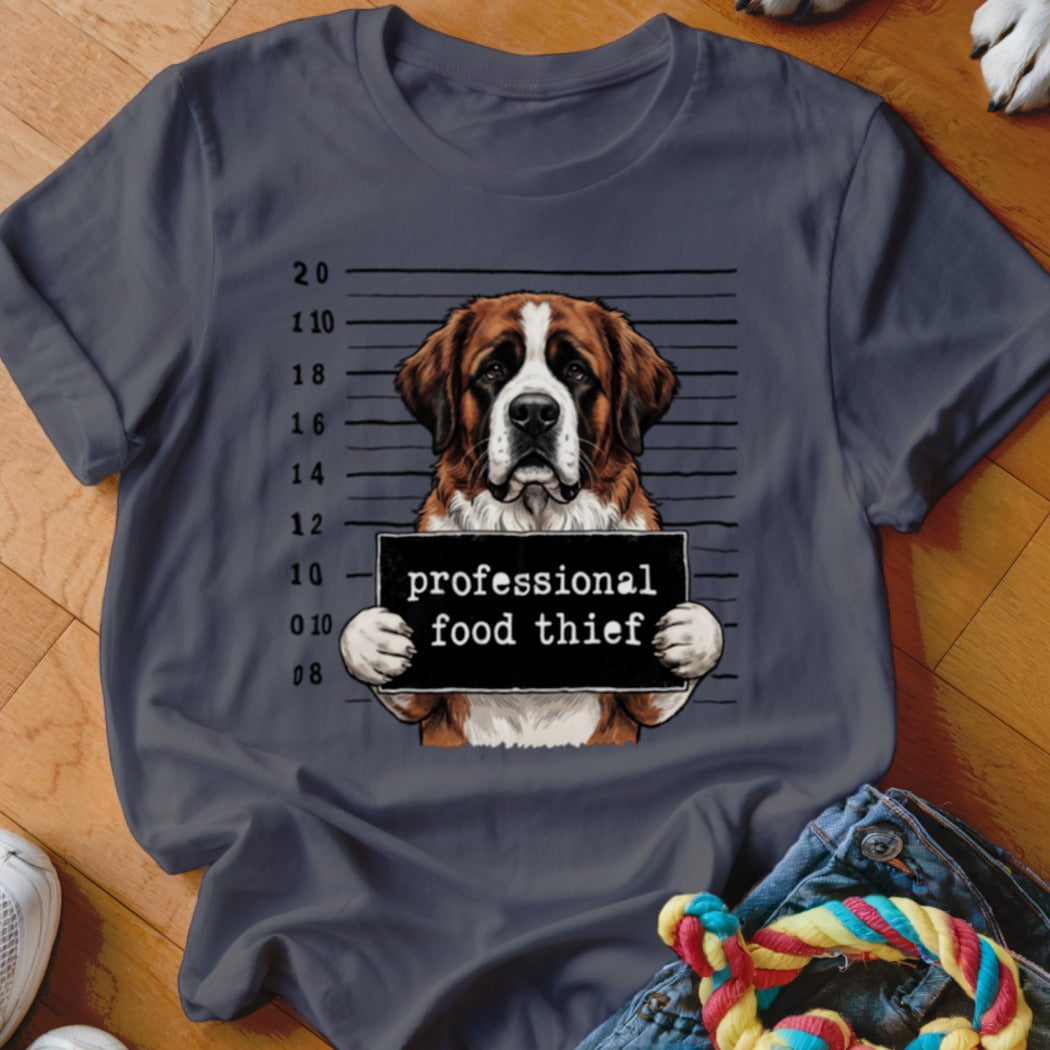 Saint Bernard dog holding a "professional food thief" sign on a mugshot background.