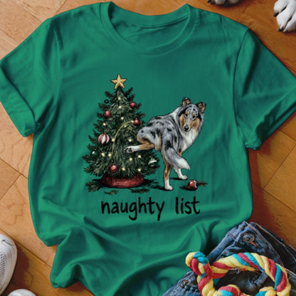 Green t-shirt with a blue merle collie dog next to a Christmas tree, text reads "naughty list".