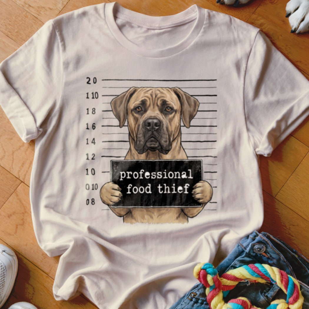 Illustration of a dog in a mugshot holding a "professional food thief" sign.
